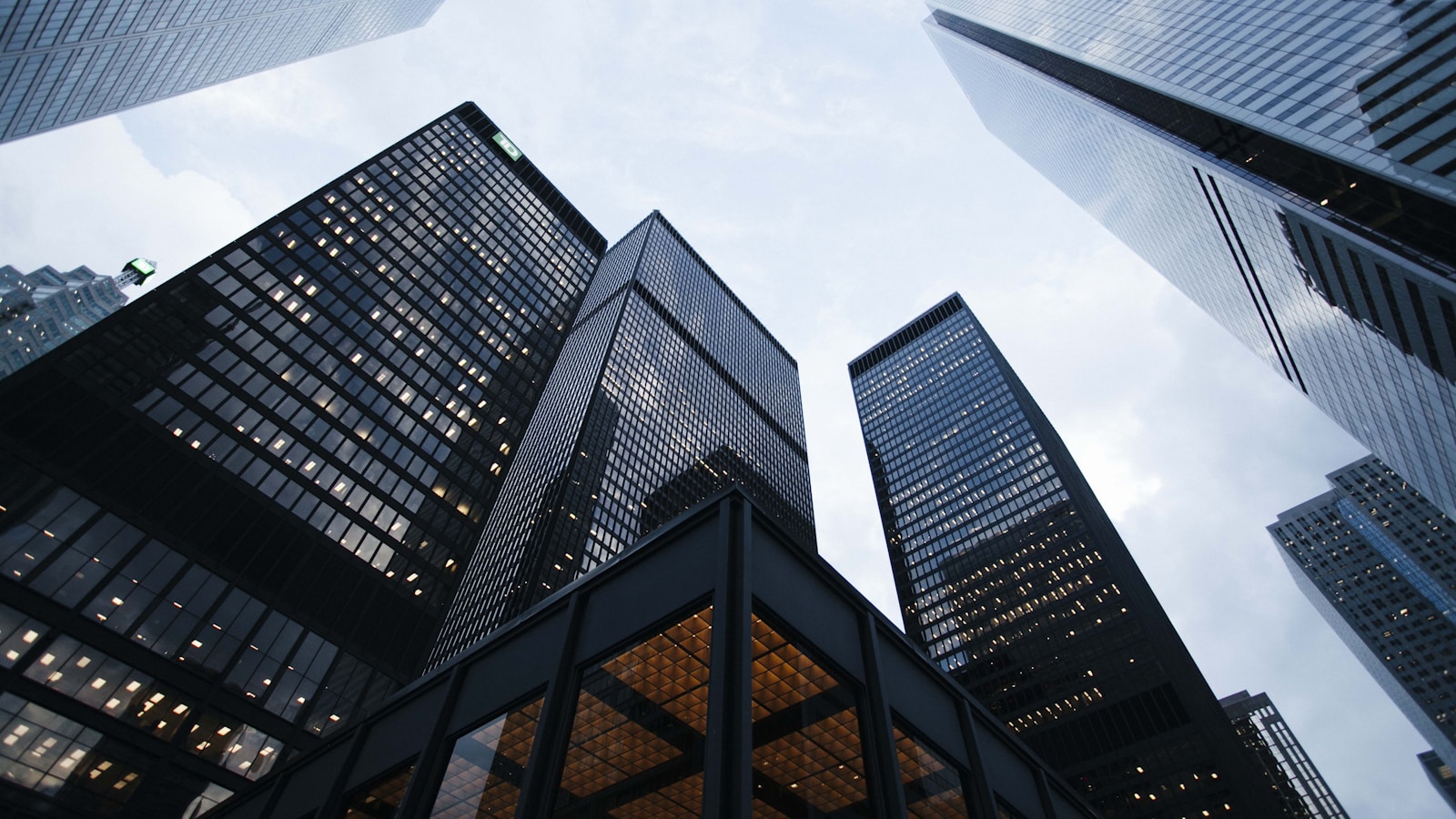 Upward view of glass corporate skyscraper representing generational estate planning and Corporate-Owned Life Insurance