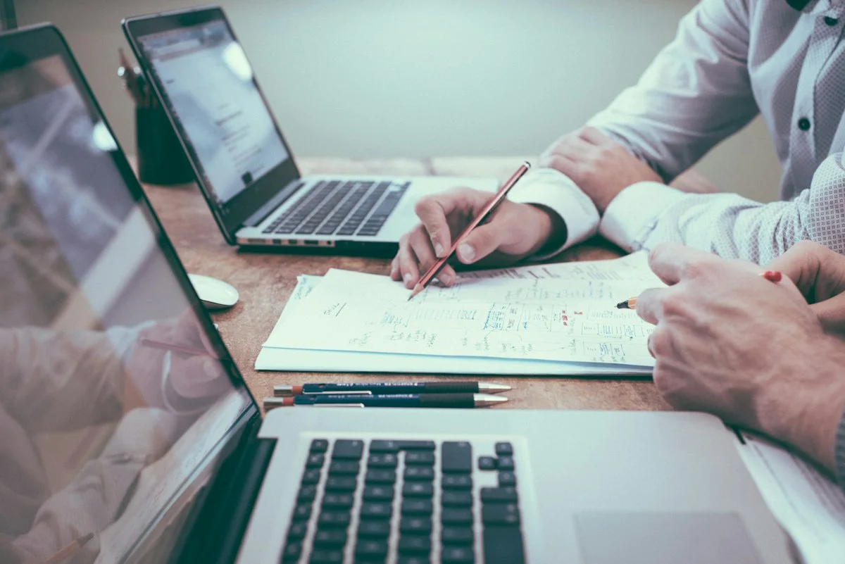 Corporate legal statutes, financial ledgers, and formal pen on Canadian executive desk