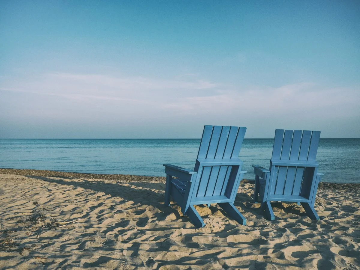 Senior couple relaxing by lakeside enjoying financial retirement security